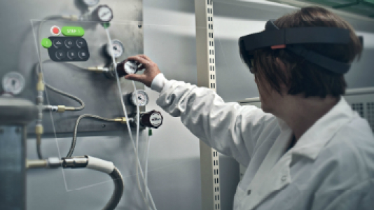 Woman using scientific equipment with a VR headset on